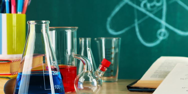 Desk,In,Chemistry,Class,With,Test,Tubes,On,Green,Blackboard